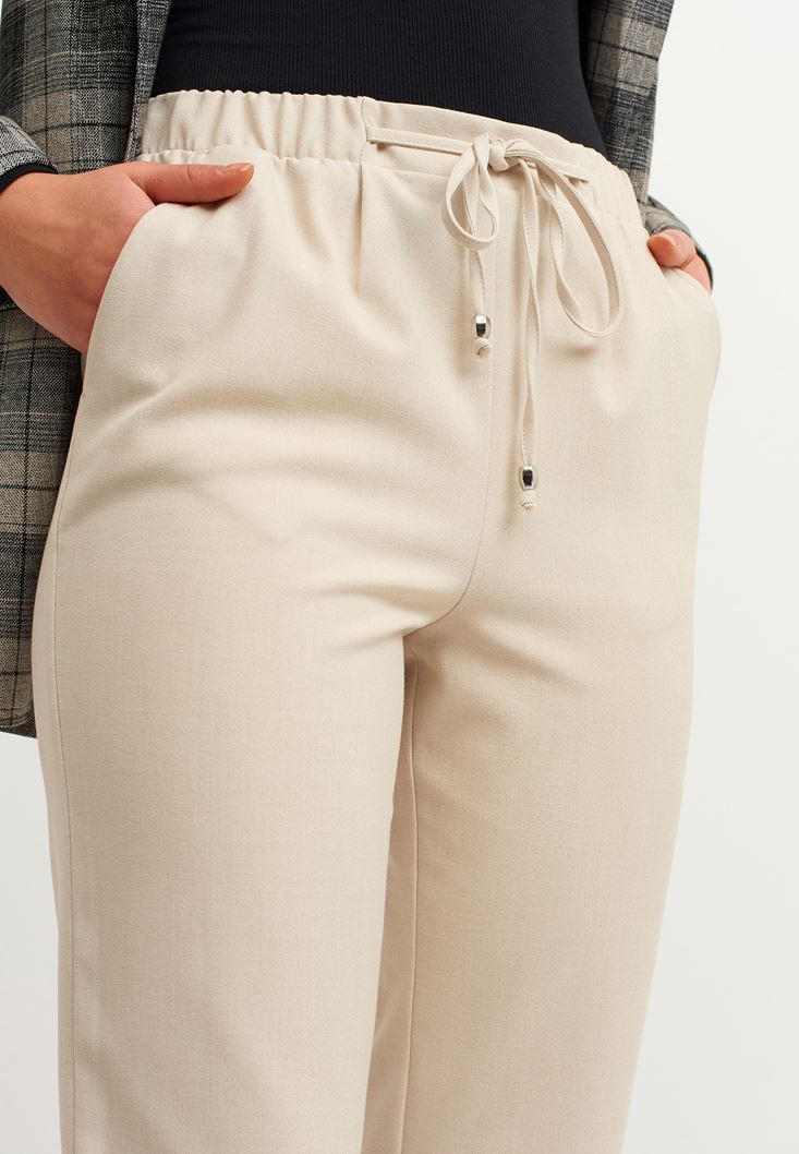 Women Beige High Rise Elastic Belly Trousers